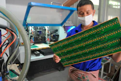 In this May 22, 2018, file photo, a staff member works in a circuit board manufacturing facility in Hangzhou in eastern China's Zhejiang province.