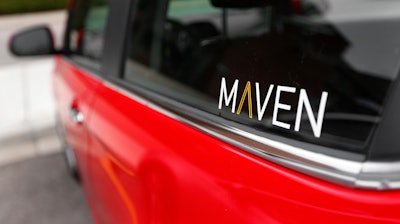 This April 27, 2016, file photo shows the Maven logo on a General Motors car-sharing service automobile in Ann Arbor, Mich.