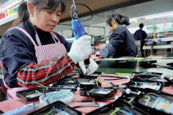 In this Saturday, March 30, 2019, file photo, workers assemble LED lights at a factory in Yushan county in central China's Jiangxi province.
