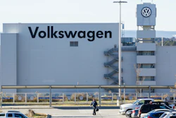 In this Dec. 4, 2015, file photo, a man walks through the employee parking lot at the Volkswagen plant in Chattanooga, Tenn.