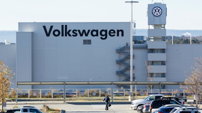 In this Dec. 4, 2015, file photo, a man walks through the employee parking lot at the Volkswagen plant in Chattanooga, Tenn.