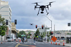 In this Tuesday, May 21, 2019 photo, two drones fly above Lake Street in downtown Reno, Nev.