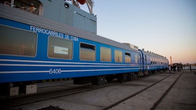 In this Monday, May 20, 2019 photo, new railroad passenger cars brought from China are inspected at their arrival in Havana.