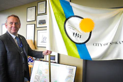 In this Tuesday, May 21, 2019, photo, Spokane Mayor David Condon displays the city's flag in his office.