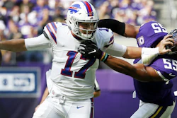 Buffalo Bills quarterback Josh Allen tries to break a tackle by Minnesota Vikings linebacker Anthony Barr during the first half of a game in Minneapolis, Sun., Sept. 23, 2018.
