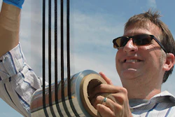 Thad Druffel, theme leader for solar manufacturing R&D at the University of Louisville's Conn Center for Renewable Energy Research, inspecting a printed roll of thin film solar cell material.