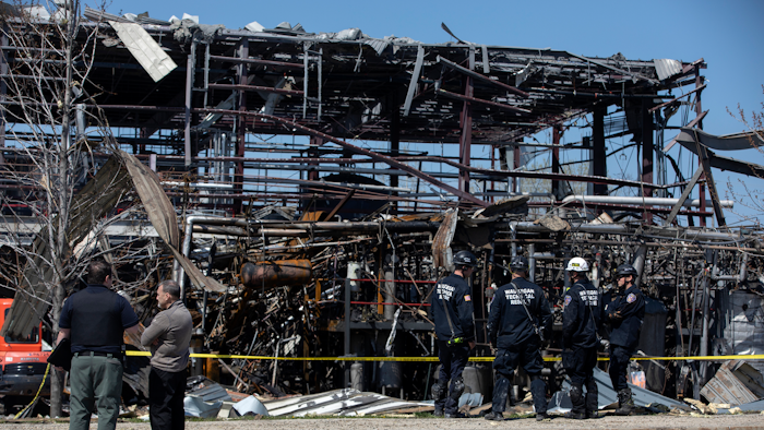 Emergency personnel and others clear the scene of an explosion at AB Specialty Silicones chemical plant, Saturday, May 4, 2019, in Waukegan, Ill.