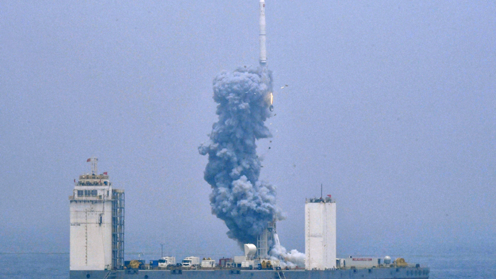In this photo released by Xinhua News Agency, a Long March-11 solid propellant carrier rocket blasts off from a mobile launch platform in the Yellow Sea, Wednesday, June 5, 2019.