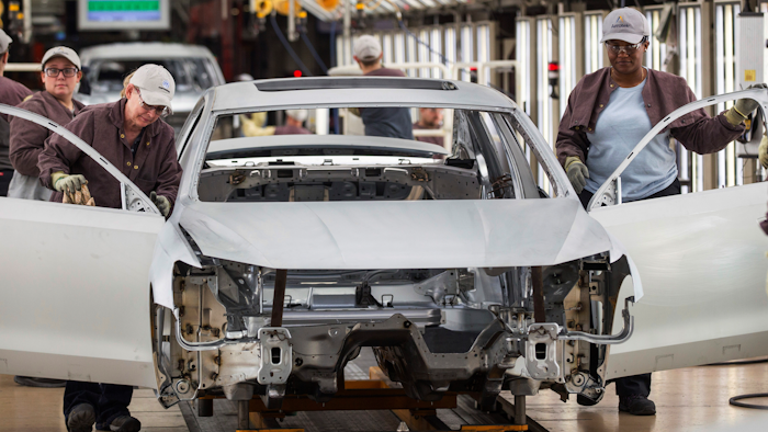 In this Aug. 31, 2017, file photo, workers produce vehicles at Volkswagen's U.S. plant in Chattanooga, Tenn.