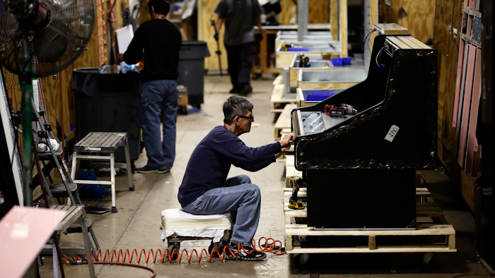In this Oct. 18, 2018, file photo, workers build refrigerators at the Howard McCray's commercial refrigeration manufacturing facility in Philadelphia.