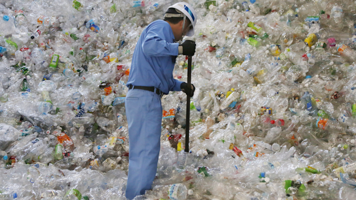 In this June 18, 2019, photo, a plastic recycling company worker sorts out plastic bottles collected for processing at Tokyo Petbottle Recycle Co., Ltd, in Tokyo. Japan has a plastic problem. Single bananas here are sometimes wrapped in plastic. So are individual pieces of vegetables, fruit, pastries, pens and cosmetics. Plastic-wrapped plastic spoons come with every ice cream cup. But as world leaders descend on Osaka for the two-day G20 Summit that starts Friday, June 28, Japan has ambitions to become a world leader in reducing plastic waste.