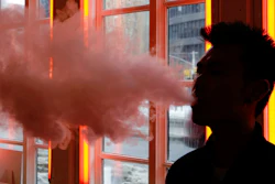 In this Feb. 20, 2014, file photo, a customer exhales vapor from an e-cigarette at a store in New York.