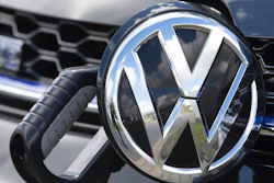 In this May 14, 2019, photo, an e-Golf car is fixed with a charging station at the Volkswagen plant in Zwickau, Germany.