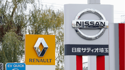 This Nov. 20, 2018, photo shows the logos of Nissan Motor Co. and Renault at car dealerships in Kawaguchi, Japan.