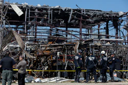Emergency personnel and others clear the scene of an explosion at AB Specialty Silicones chemical plant, Saturday, May 4, 2019, in Waukegan, Ill.