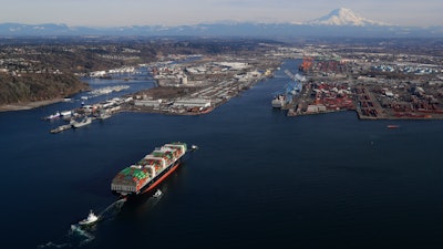 In this March 5, 2019, file photo, a cargo ship arrives at the Port of Tacoma, in Tacoma, Wash.