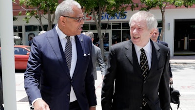 Carnival Corp. President Arnold Donald, left, arrives at federal court, Monday, June 3, 2019, in Miami.