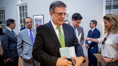 Mexican Foreign Affairs Secretary Marcelo Ebrard departs a news conference at the Mexican Embassy in Washington, Tuesday, June 4, 2019.