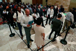 In this Tuesday, June 4, 2019, photo, job applicants line up at the Seminole Hard Rock Hotel & Casino Hollywood during a job fair in Hollywood, Fla.