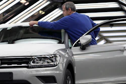 In this Thursday, March 8, 2018, photo, an employee works on a car during a final quality control at the Volkswagen plant in Wolfsburg, Germany.
