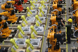 A worker checks on robot arms at a factory in Nanjing in east China's Jiangsu province, Thursday, June 6, 2019.