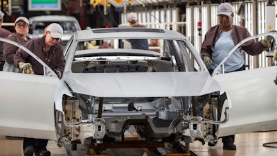 In this Aug. 31, 2017, file photo, workers produce vehicles at Volkswagen's U.S. plant in Chattanooga, Tenn.