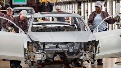 In this Aug. 31, 2017, file photo, workers produce vehicles at Volkswagen's U.S. plant in Chattanooga, Tenn.