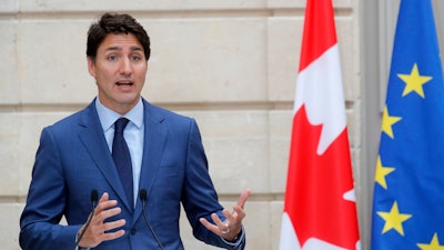 Canadian Prime Minister Justin Trudeau speaks during a press conference at the Elysee Palace in Paris, Friday, June 7, 2019.