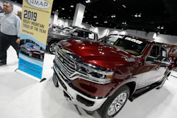 In this March 28, 2019, file photo, buyers look over a 2019 Ram pickup truck on display at the auto show in Denver.