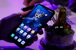 In this Tuesday, May 21, 2019, file photo, a member of the media tries out new Huawei Honor 20 series of phones following their global launch in London.