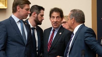 House Judiciary Committee members Rep. Eric Swalwell, D-Calif., far left, Rep. Jamie Raskin, D-Md., center, and Rep. David Cicilline, D-R.I., far right, talk before a hearing on Capitol Hill, Monday, June 10, 2019.