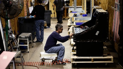 In this Oct. 18, 2018, file photo, workers build refrigerators at the Howard McCray's commercial refrigeration manufacturing facility in Philadelphia.