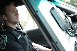 In this Wednesday, May 8, 2019, photo, Officer T. Scott Masten works a shift in Anchorage equipped with a wireless hotspot device on his patrol car laptop.