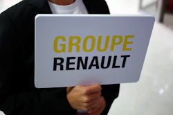 A hostess holds a sign to show the way for the Renault shareholders general meeting in Paris, Wednesday, June 12, 2019.