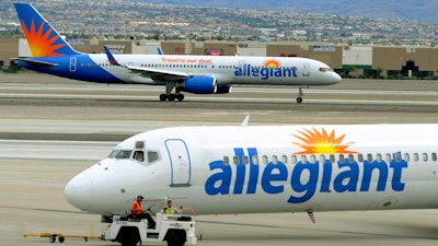 In this May 9, 2013, file photo, two Allegiant Air jets taxi at McCarran International Airport in Las Vegas.