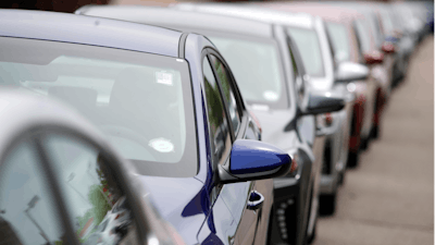 In this May 19, 2019, file photo, a long line of unsold 2019 sedans sits at a dealership in Littleton, Colo.