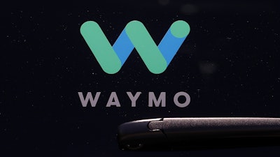 This Tuesday, May 8, 2018, file photo shows a Waymo logo on the window of a car at the Google I/O conference in Mountain View, Calif.