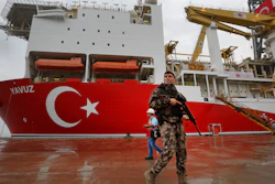 A police officer patrols near the drilling ship Yavuz at the port of Dilovasi, Turkey, Thursday, June 20, 2019.