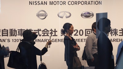Shareholders arrive for Nissan's general meeting of shareholders in Yokohama, Tuesday, June 25, 2019.