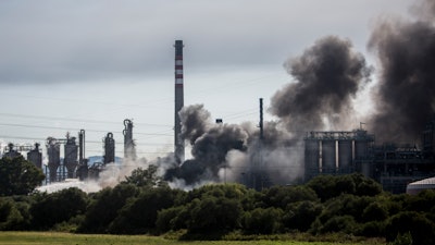 A plume of smoke rises during a fire at the Indorama Ventures petrochemical plant in San Roque, Spain, Tuesday, June 25, 2019.