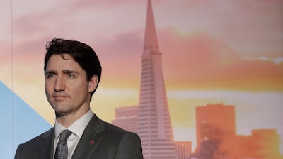 In this Feb. 8, 2018, photo, Canadian Prime Minister Justin Trudeau waits to speak at the AppDirect office in San Francisco.