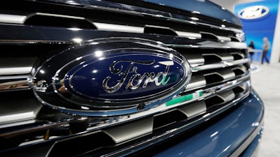 In this Thursday, March 28, 2019, file photo, the Ford logo is shown at an auto show in Denver.