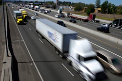 In this Wednesday, Aug. 24, 2016, file photo, truck and automobile traffic mix on Interstate 5, headed north through Fife, Wash., near the Port of Tacoma.
