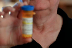 In this April 8, 2019, photo at his home in Derry, Pa., Chuck Pope shows the only medication he uses now to alleviate his rheumatoid arthritis condition.