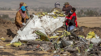 Clearing away the wreckage after a Boeing 737 Max aircraft crashed near Addis Ababa.