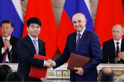 Guo Ping, deputy Chairman of Huawei Technologies Co Ltd, foreground left, shakes hands with Russian President of MTS mobile network operator, Alexei Kornya as Russian President Vladimir Putin, right, and Chinese President Xi Jinping attend a signing ceremony following their talks in the Kremlin in Moscow, Russia, Wednesday, June 5, 2019. Chinese President Xi Jinping is on visit to Russia this week and is expected to attend Russia's main economic conference in St. Petersburg.