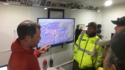 This April 17, 2017, photo provided by Michael St. John shows search and rescue volunteer and SARTopo creator Matt Jacobs, left, and search and rescue volunteers Mike Russo, center, and Bob Gehlen, right, in Sierraville, California, as they consult a SARTopo map while making plans to search for a missing aircraft. The dramatic rescue of a hiker lost for more than two weeks in a remote Hawaii forest is showing how emerging technology is helping search teams more efficiently scour the wilderness for missing people.