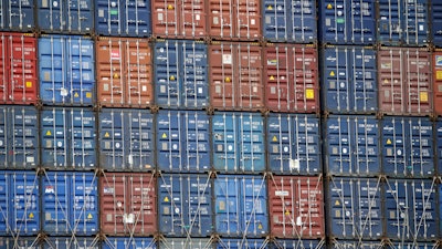 In this June 19, 2019, file photo cargo containers are stacked on a ship at the Port of Los Angeles in Los Angeles. Manufacturers see the Trump administration’s trade policies as a bigger challenge than the economy. That’s one of the findings of a quarterly survey by the National Association of Manufacturers, or NAM, released last week.