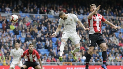 Real Madrid’s Karim Benzema heads for the ball to score during a Spanish La Liga soccer match between Real Madrid and Athletic Bilbao in Madrid, Sunday, April 21, 2019.
