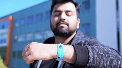 Co-creator Muhammad Umair wearing one of the prototype smart materials wrist bands.